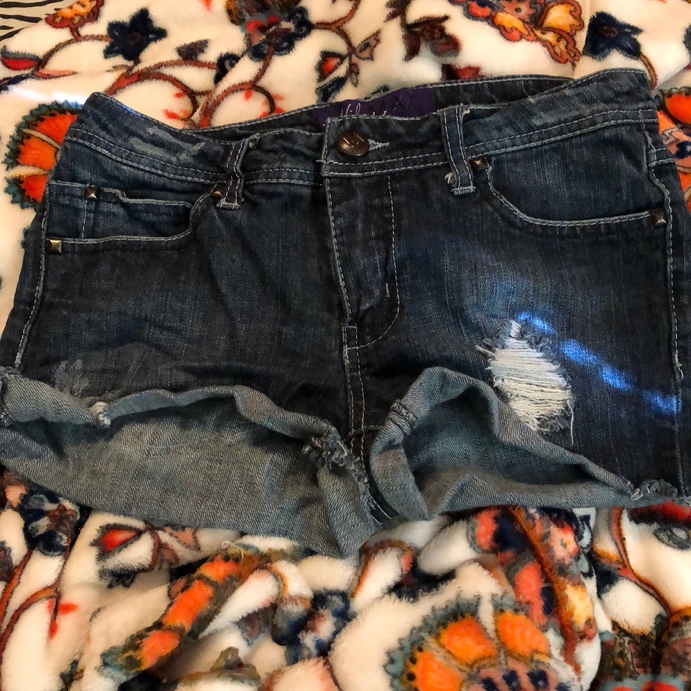Miley Cyrus dark wash shorts.